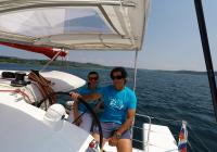 skipper and girl behind steering wheel of trimaran neel 45 yacht 1